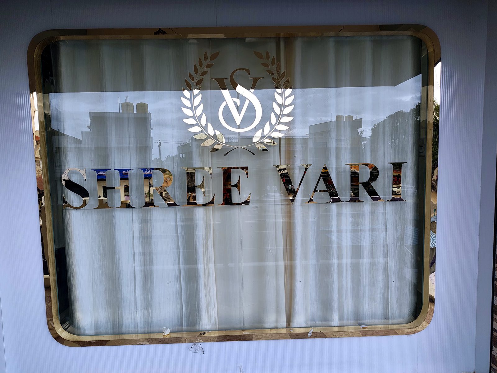 Shree Vari gold nameplate on the glass entrance